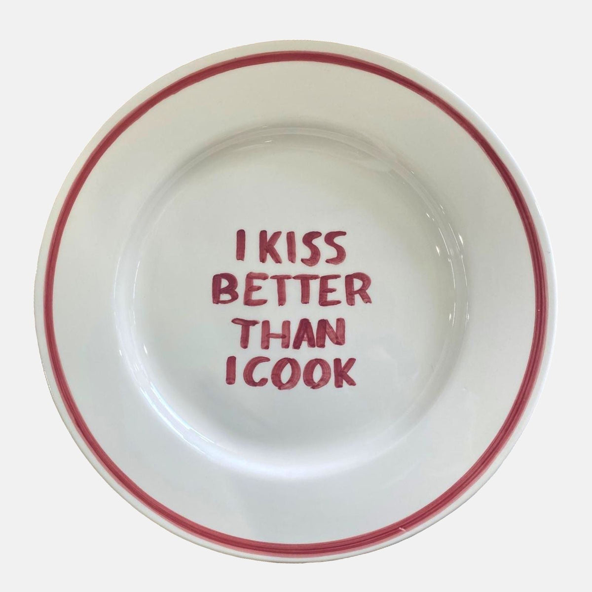 'I kiss better than I cook' bord
